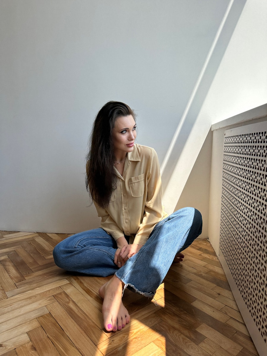 a woman sitting on the floor with her legs crossed